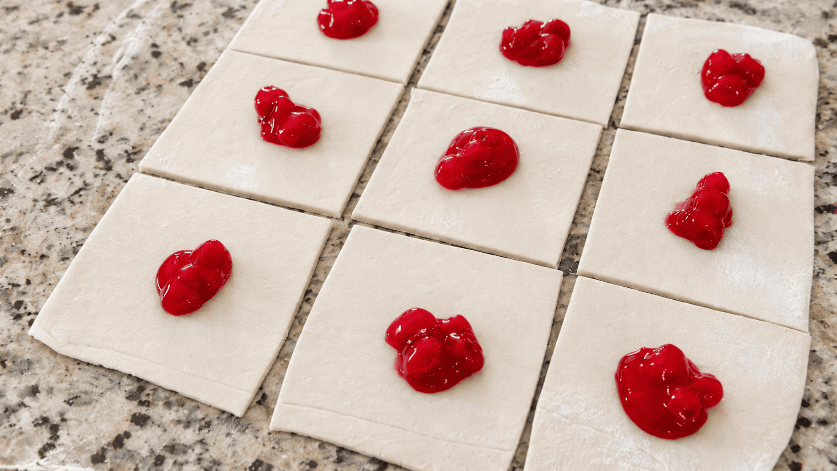 Squares of puff pastry dough with filling.