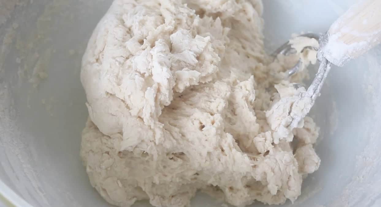 Hamburger bun dough in a mixing bowl.