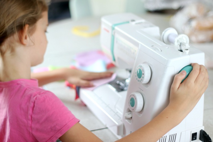 girl sewing on sewing machine