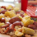 low country boil spread across table with brown paper