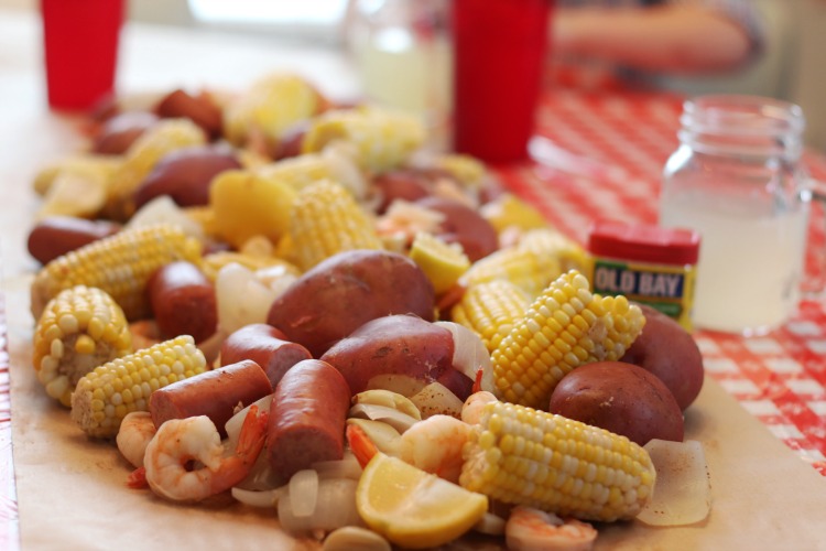 low country boil spread across table with brown paper