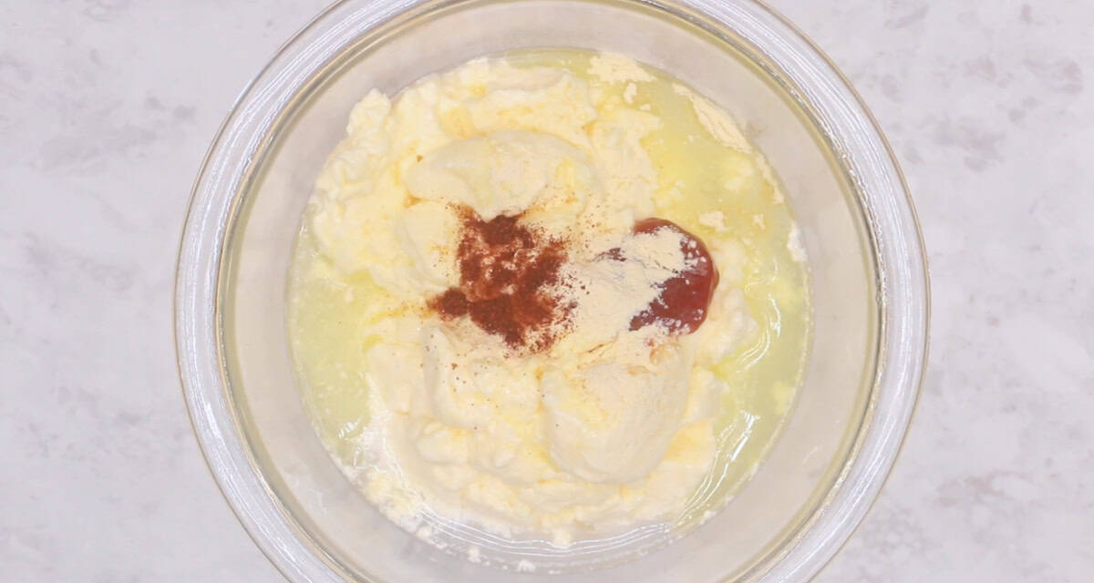 Bowl of mayonnaise, paprika, water, sugar, butter and garlic powder.