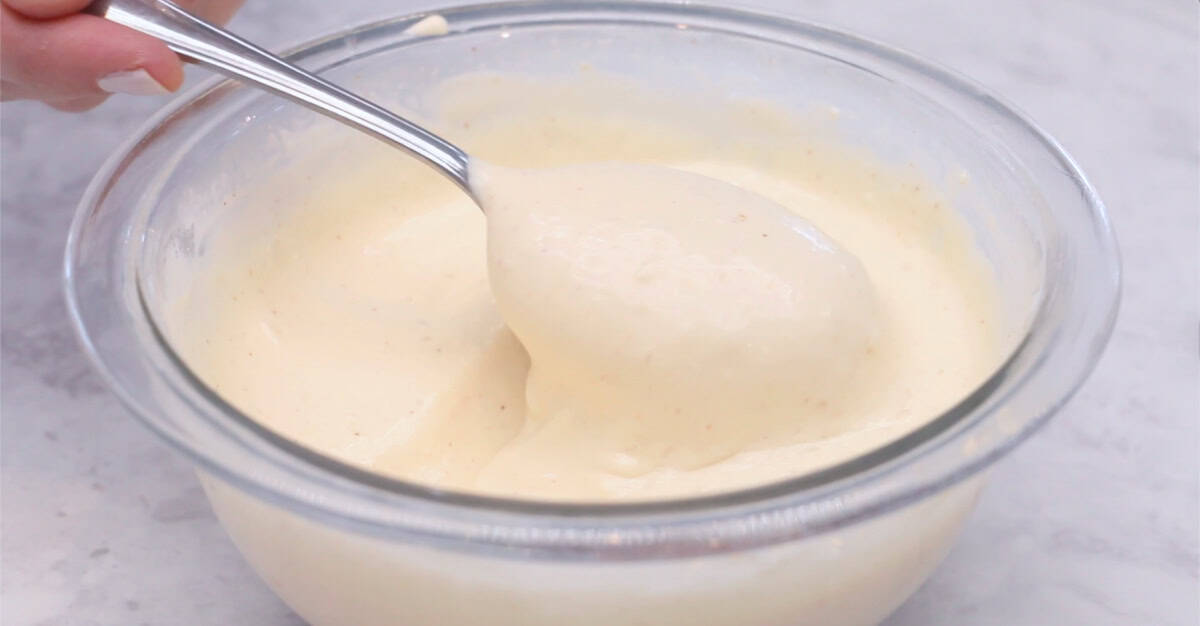 Bowl of yum yum sauce with spoon scooping out a portion of it.