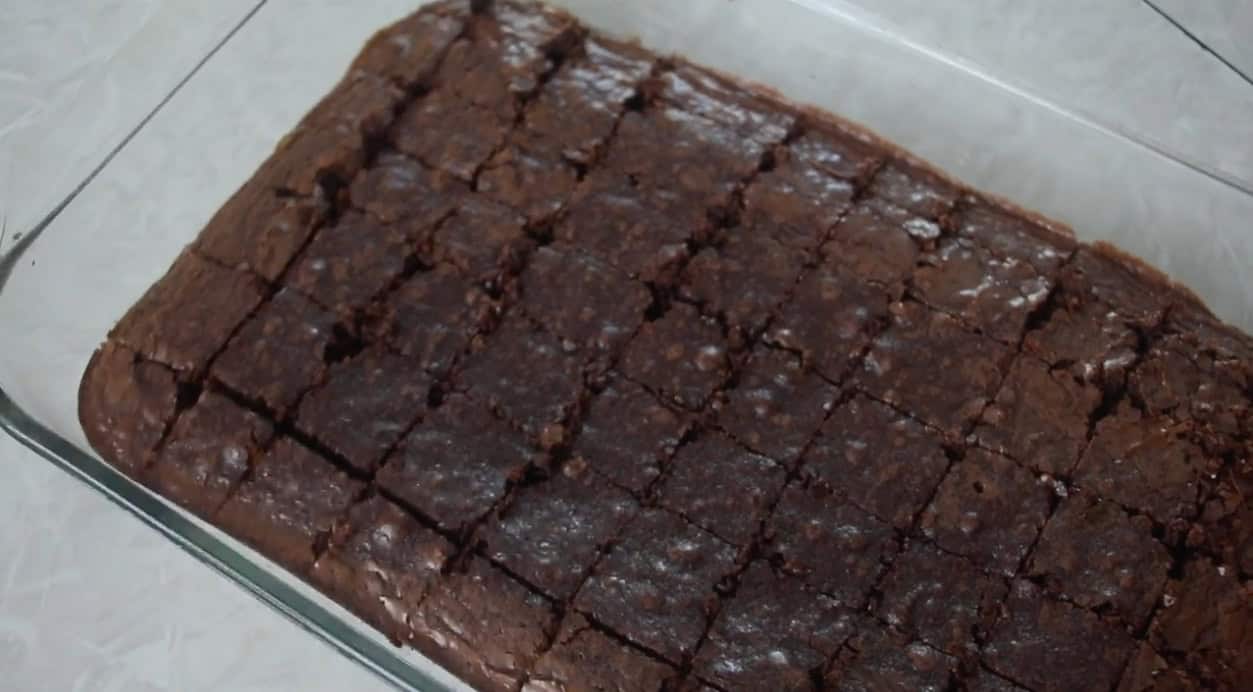 Glass dish with baked brownies cut into 1" squares.