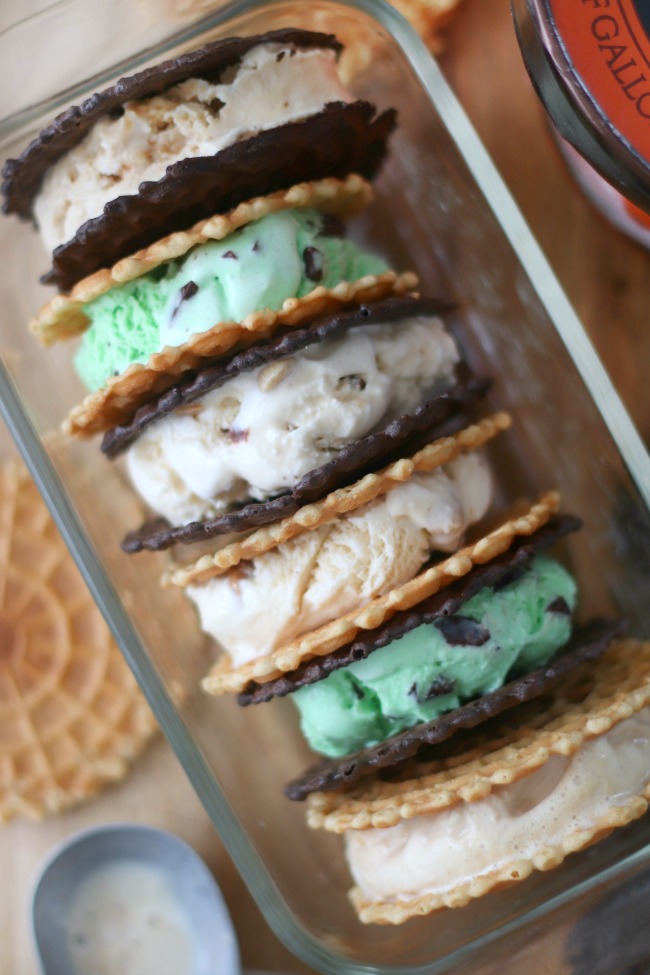 six pizzelle ice cream sandwiches lined up in glass serving dish