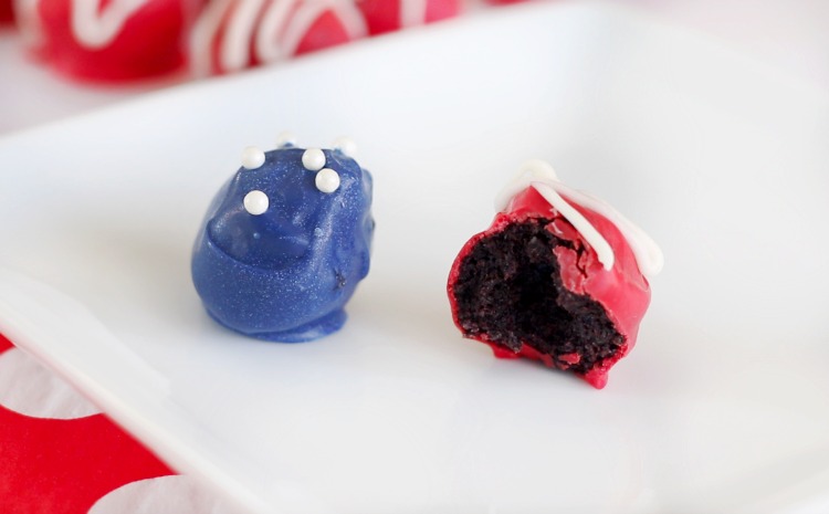 two Oreo truffles on white plate