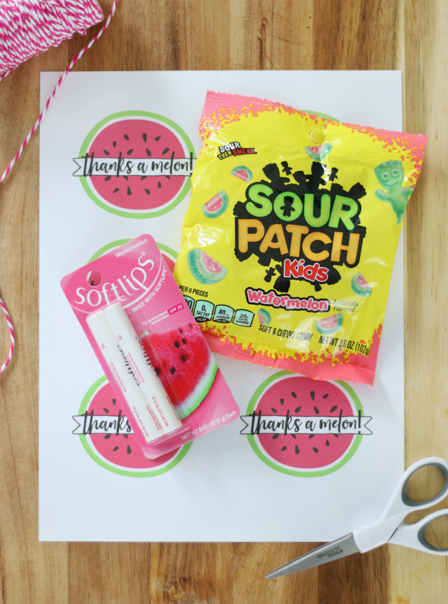 sheet of printable tags with lip gloss and candy on table