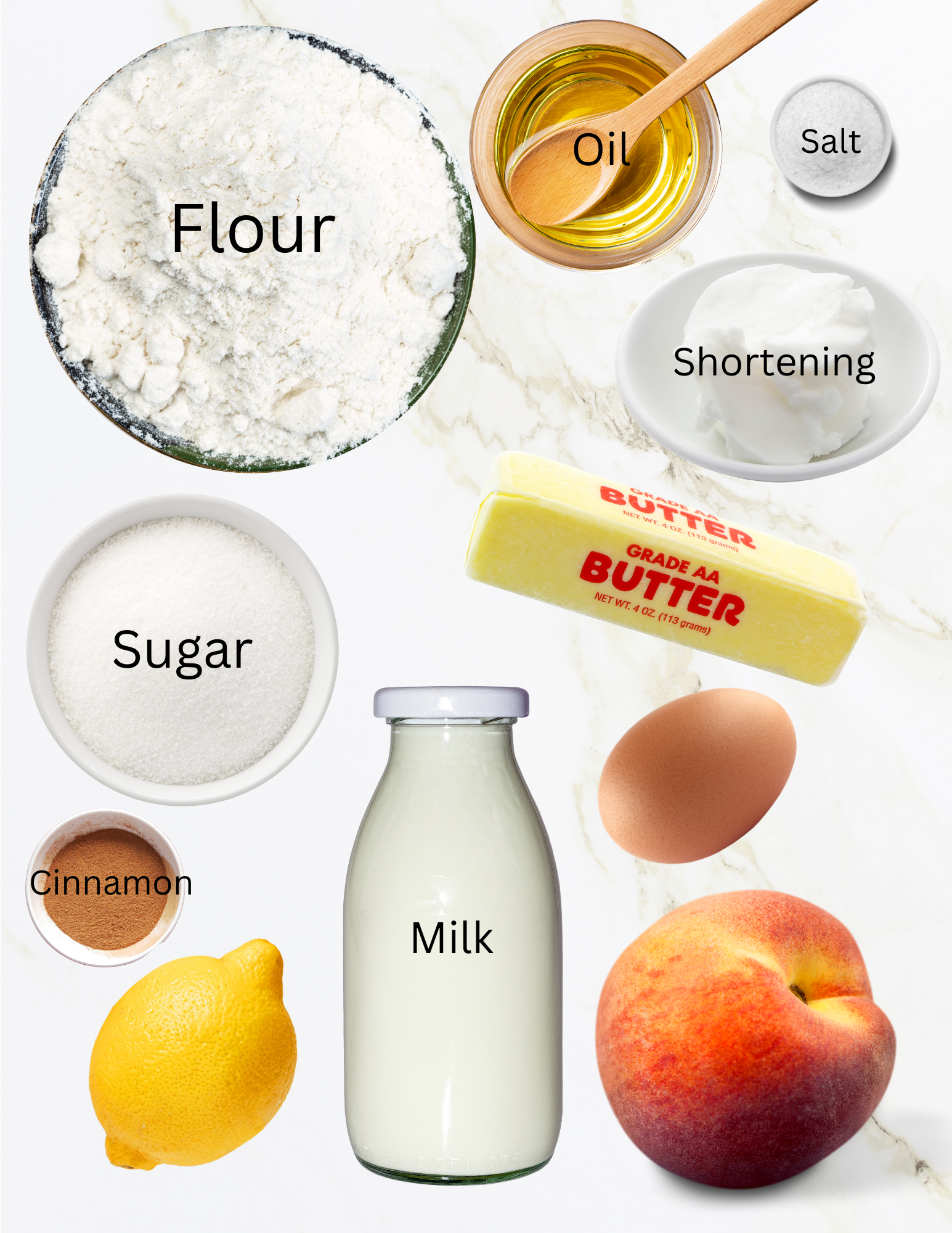 Bowls of flour, oil, shortening, sugar, cinnamon and salt with a stick of butter, bottle of milk, egg, peach and lemon.