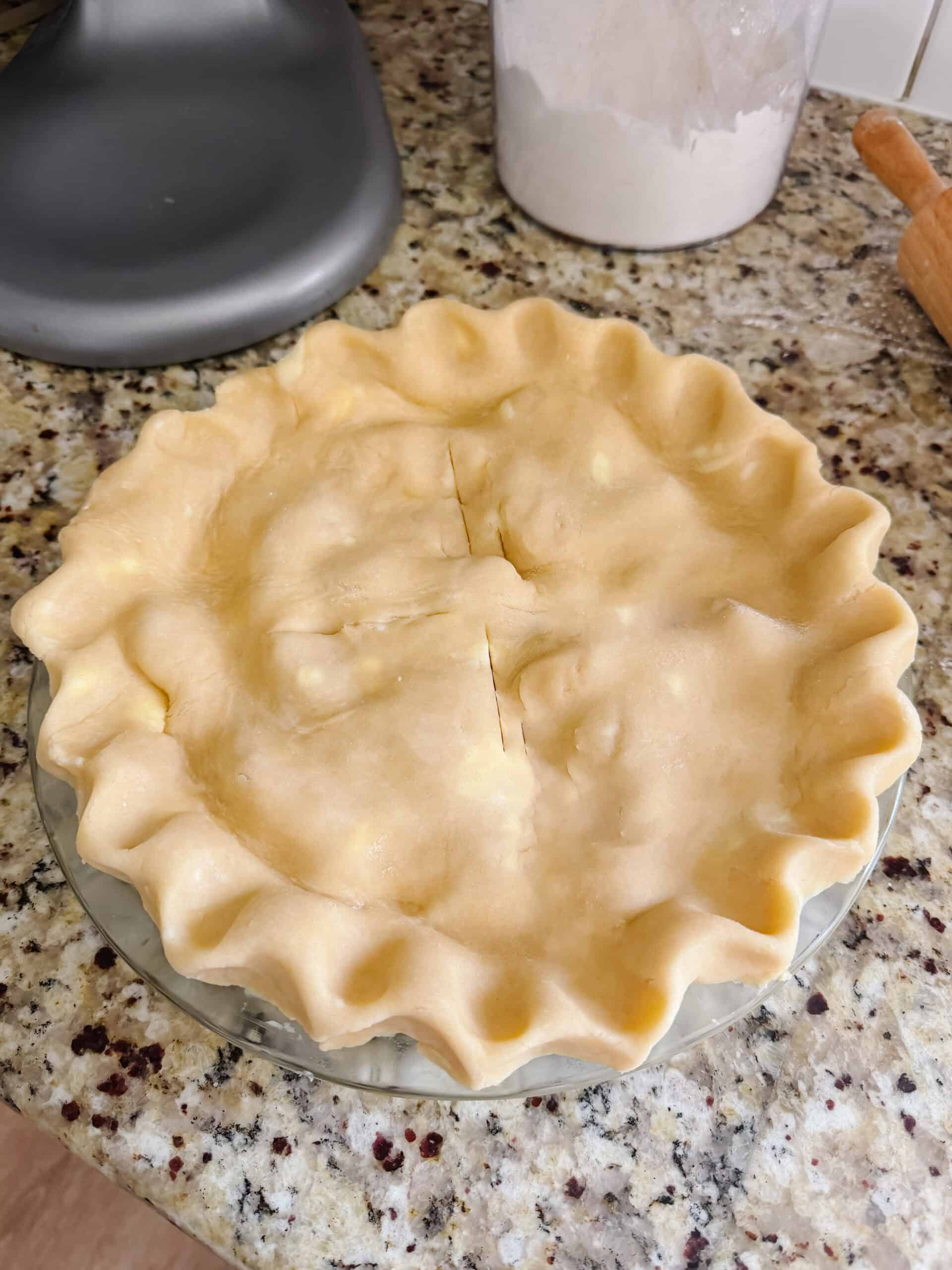 Unbaked pie on kitchen counter.