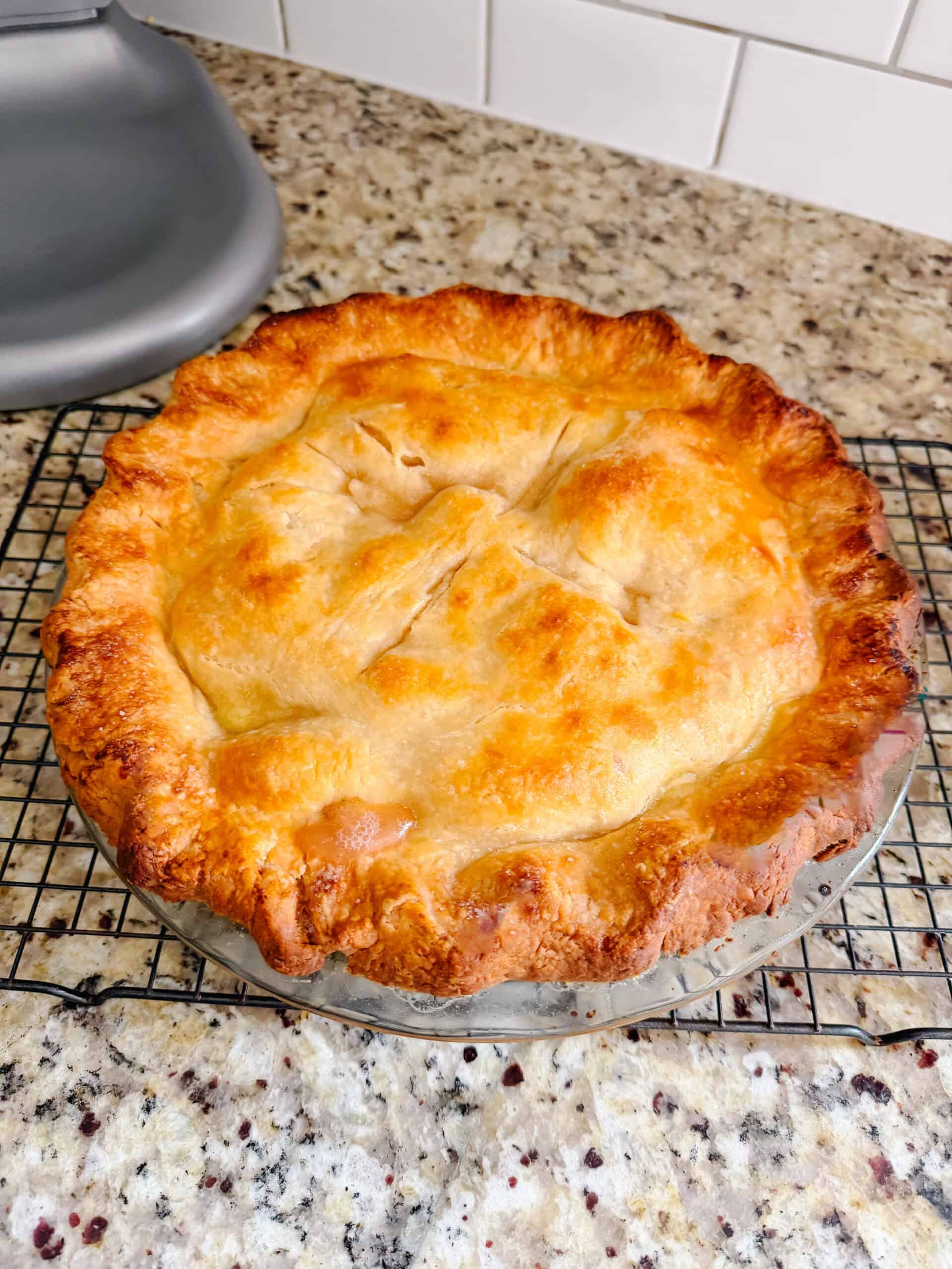 Peach pie cooling on counter.