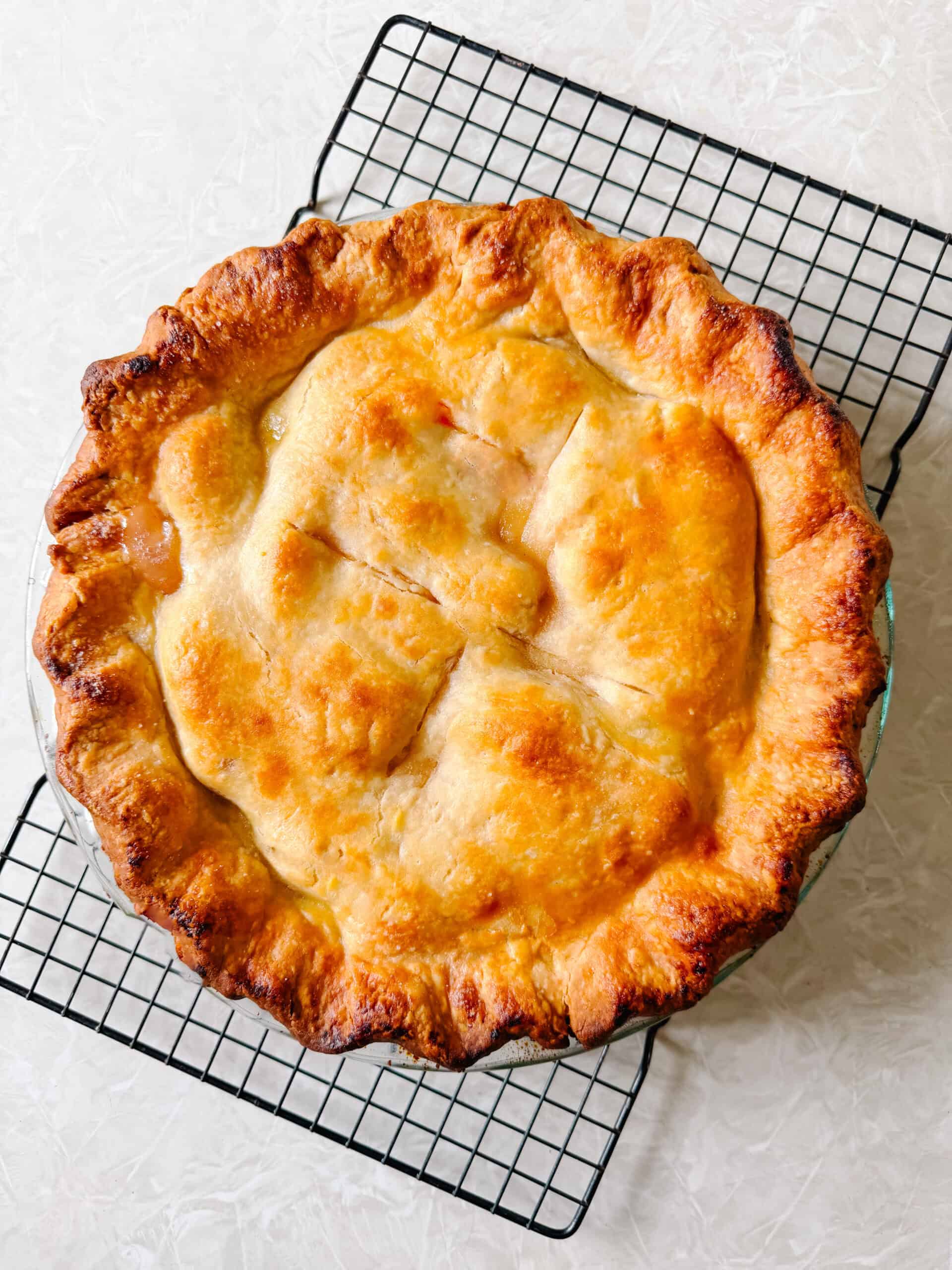 Baked pie on wire cooling rack.