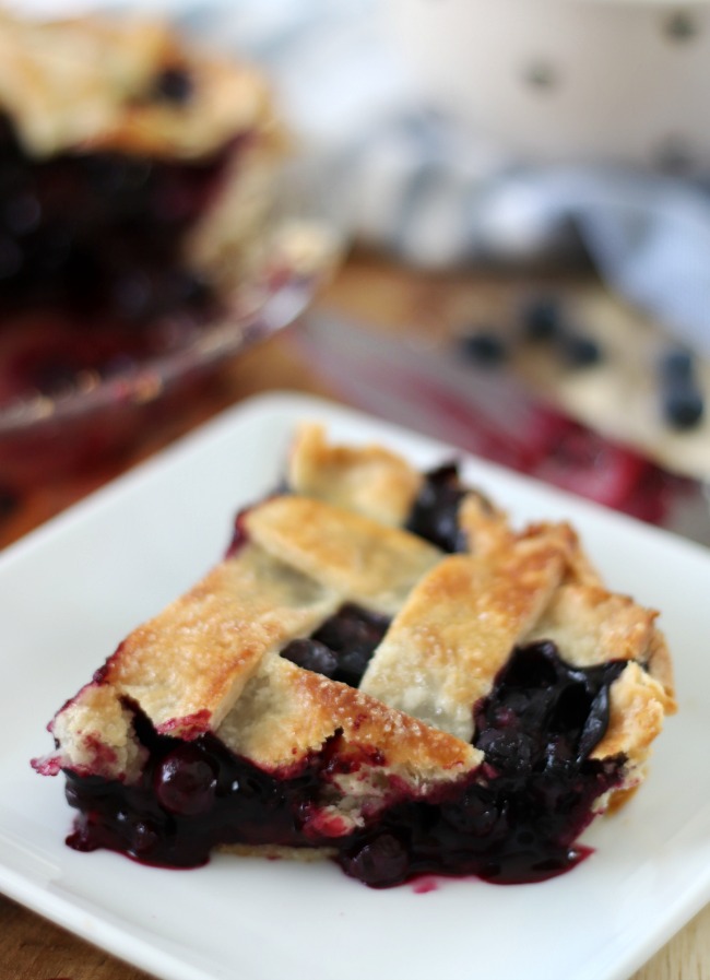 slice of blueberry pie on white plate