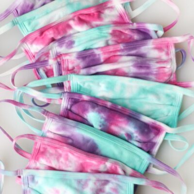 ten tie dyed face masks stacked
