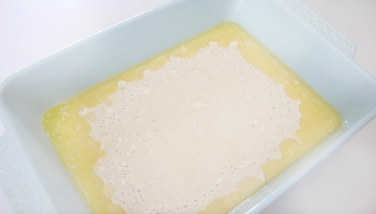batter poured over melted butter in baking dish