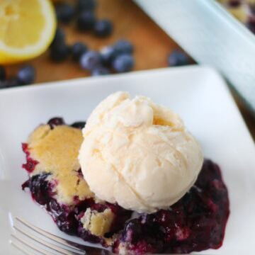 serving of blueberry cobbler with a scoop of vanilla ice cream on top