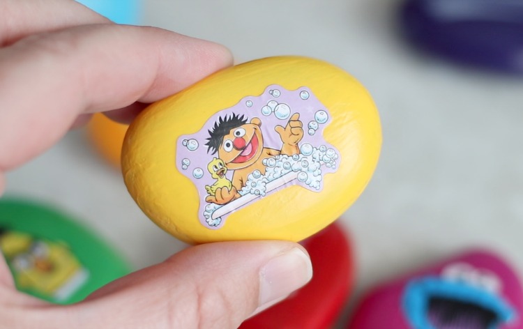 yellow painted rock with ernie sticker from sesame street
