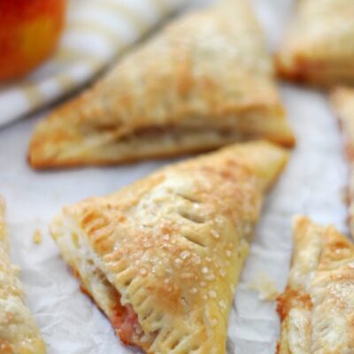 baked peach turnovers on baking sheet