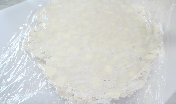 puff pastry in between plastic wrap and rolled out