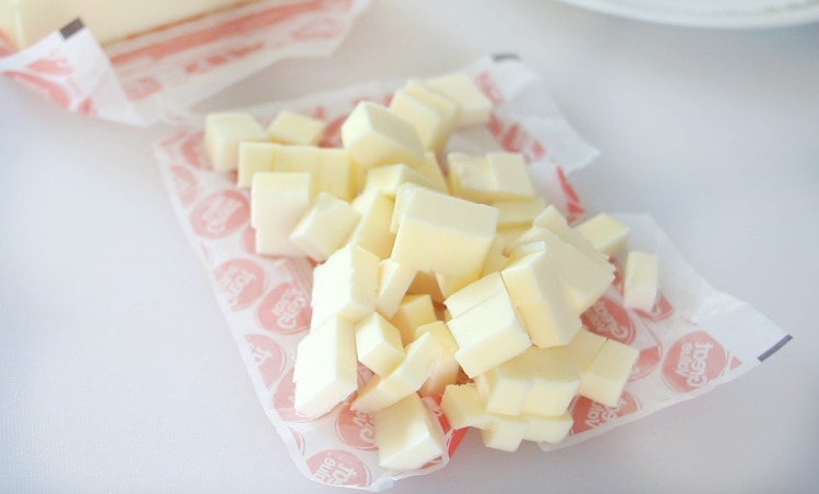 cold butter cut into tiny cubes on cutting board