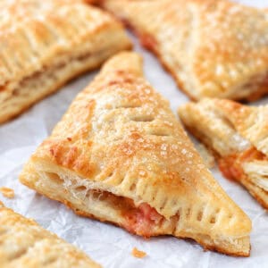 Peach turnovers on parchment paper.