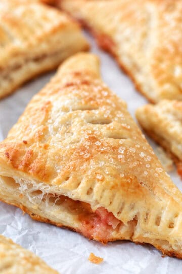 Peach turnovers on parchment paper.