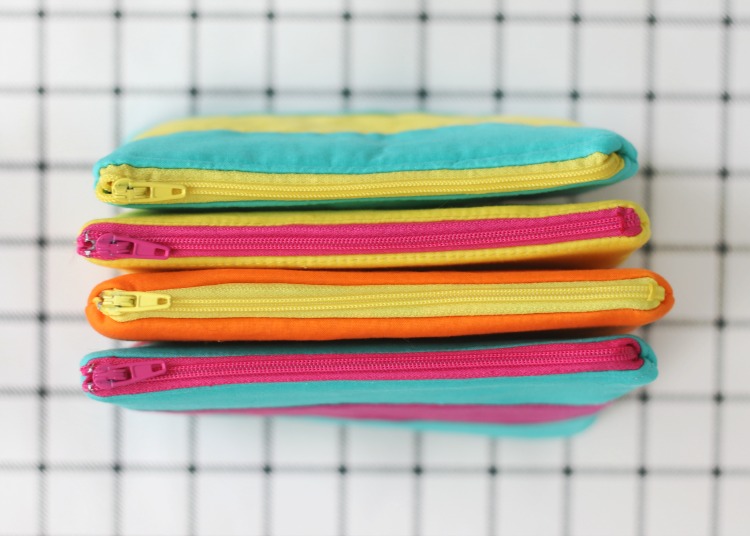 four bags with colorful zippers