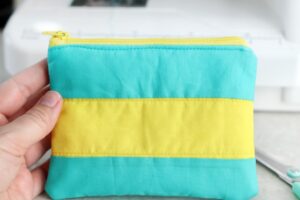 hand holding finished color blocked cosmetic bag