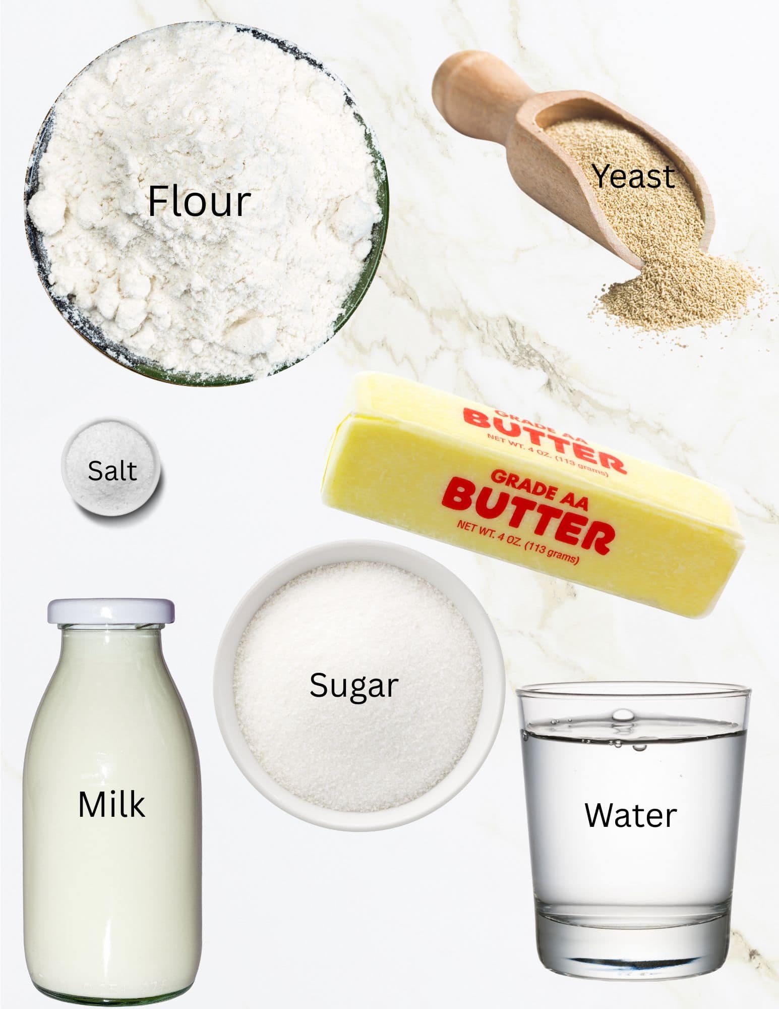 Bowls of flour, salt, sugar, yeast, bottle of milk, water and stick of butter.