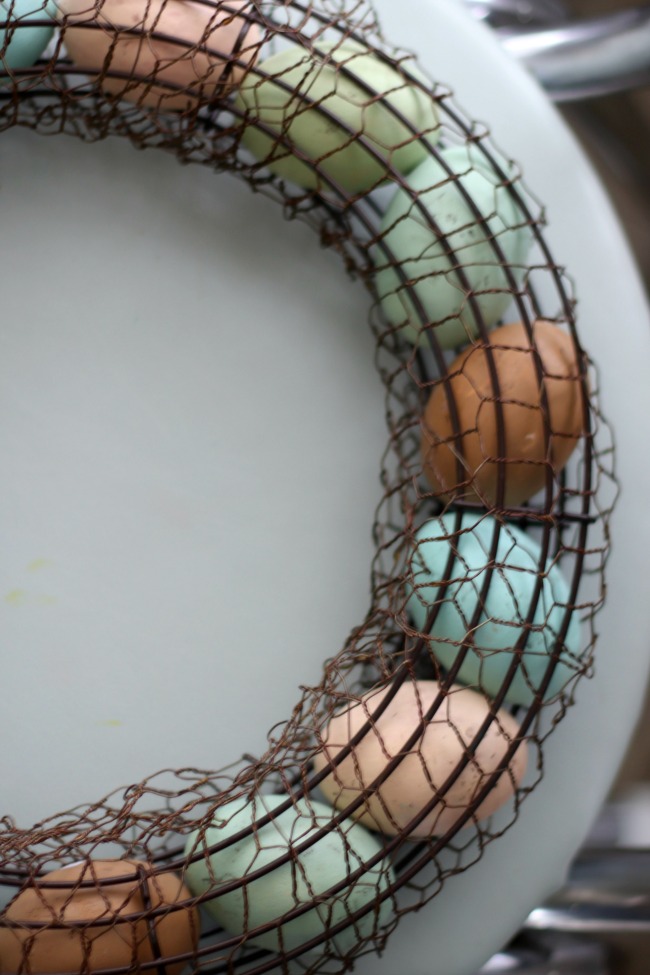 painted wooden eggs inside wreath form