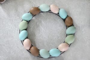 wire wreath base with painted wooden eggs