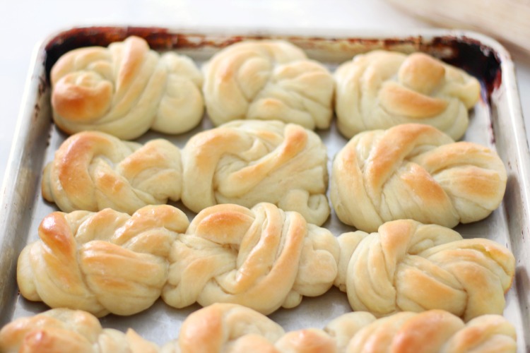 knotted dinner rolls brushed with butter