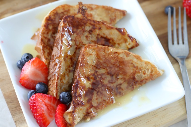french toast drizzled in caramel syrup with fresh fruit
