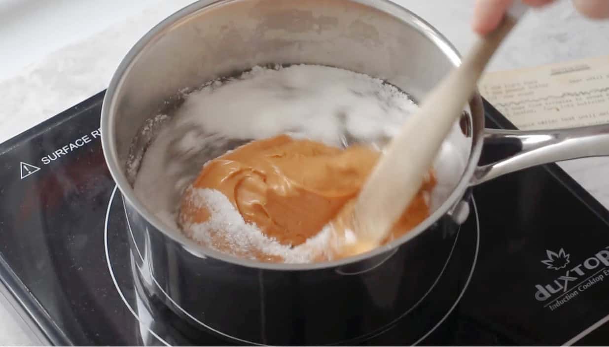 Sauce pan with sugar, peanut butter and corn syrup.