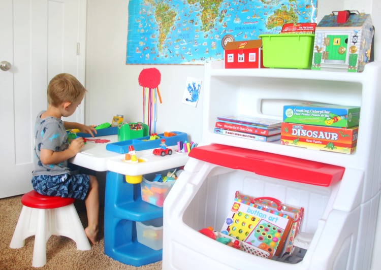 child sitting at preschool art table