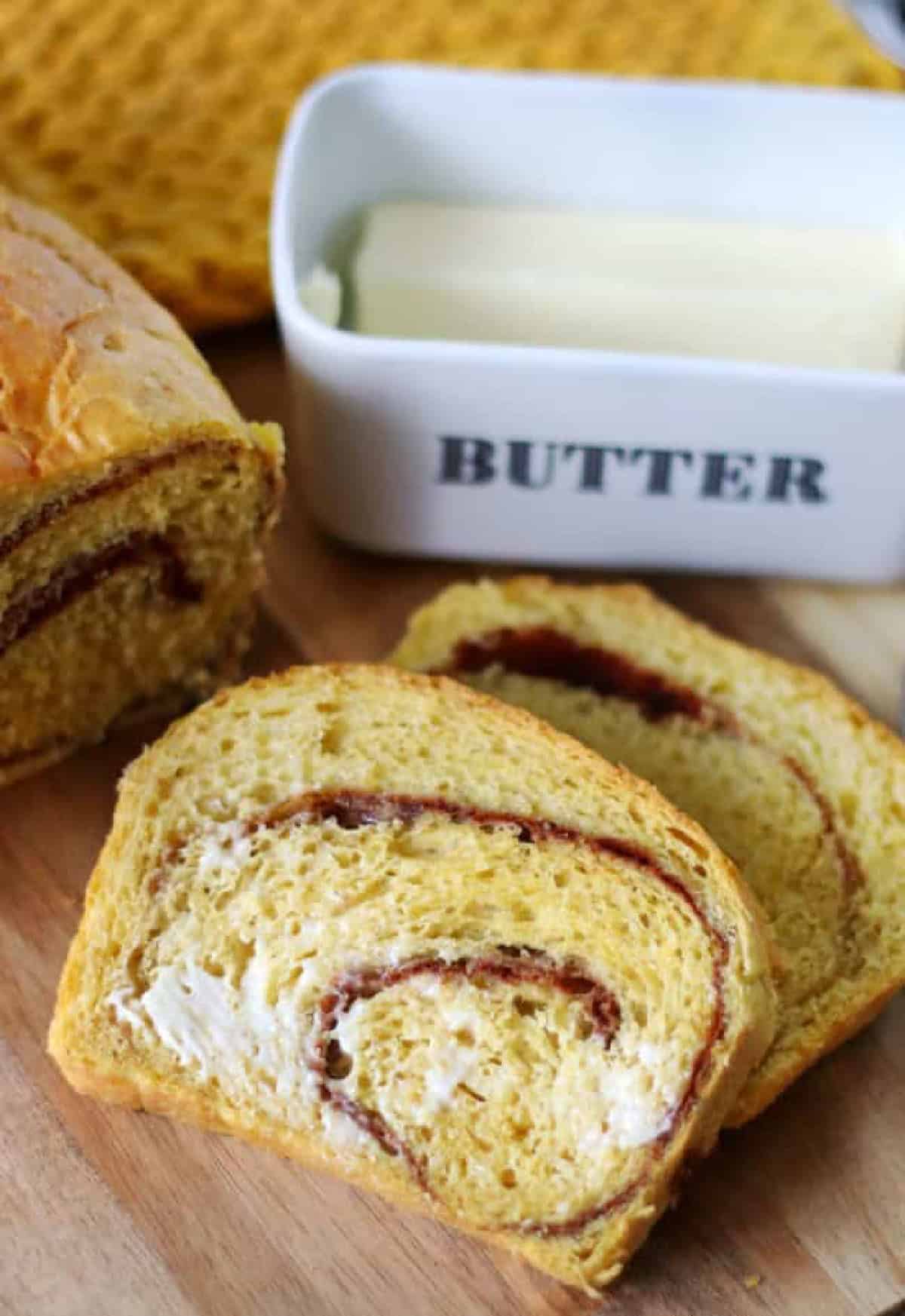 Two slices of buttered pumpkin swirl bread.