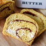 Two slices of buttered pumpkin swirl bread.