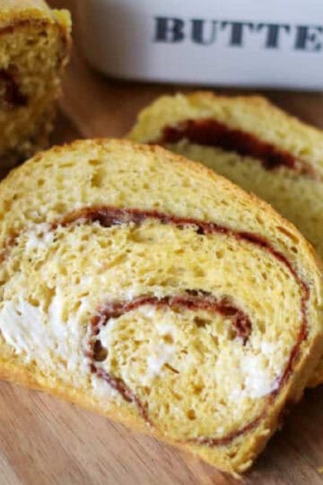 Two slices of buttered pumpkin swirl bread.