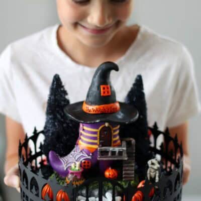 child holding halloween fairy garden