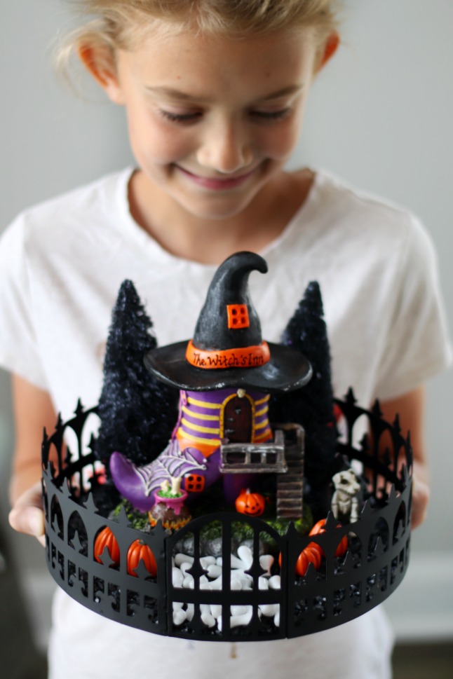 child holding halloween fairy garden