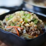 egg roll bowl with fried wonton strips and green onions