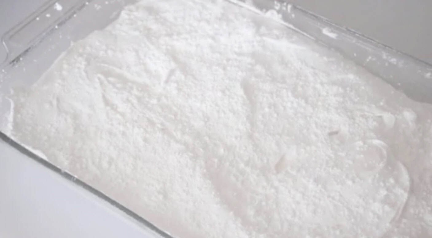 Tray of marshmallows pressed and sprinkled with powdered sugar.