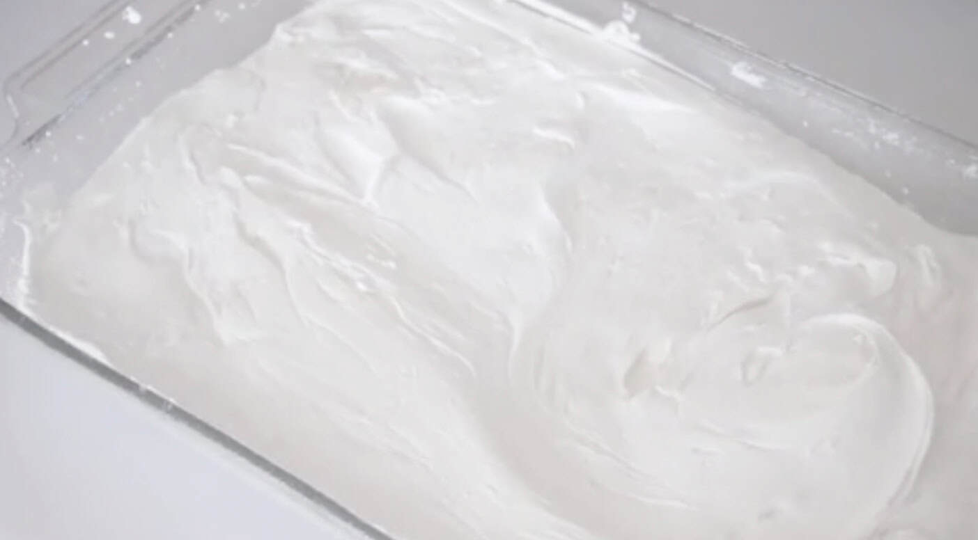Marshmallow mixture pressed into tray.