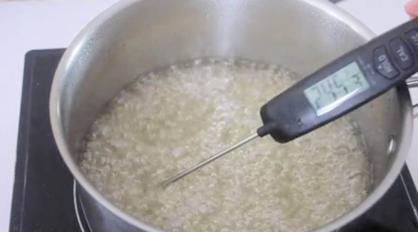 Pan of boiling sugar mixture and thermometer.