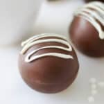 Hot chocolate bomb with white chocolate drizzle.