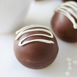 Hot chocolate bomb with white chocolate drizzle.