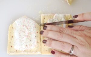 hand holding serrated knife to cut pop tarts