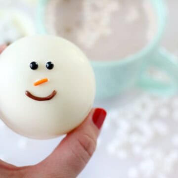 hand holding snowman hot chocolate bomb