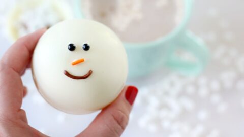 hand holding snowman hot chocolate bomb