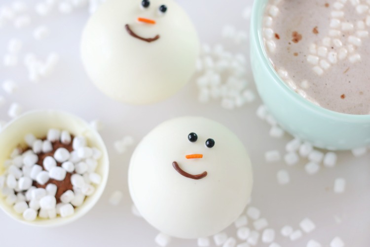 two snowman hot chocolate bombs on table