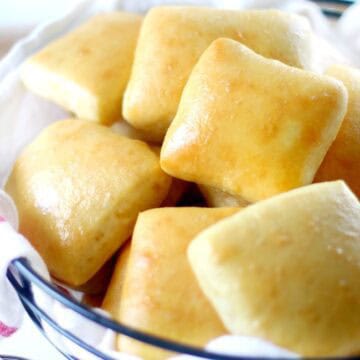 rolls in basket with dish towel